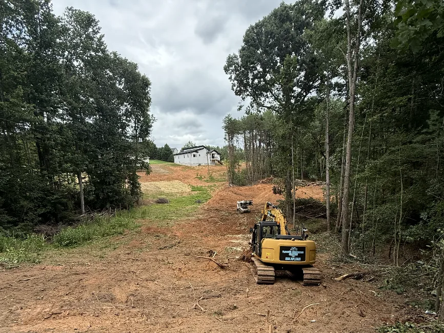 Excavator and skid steer clearing a residential homesite in the Hickory, NC area β Platinum Construction & Crane