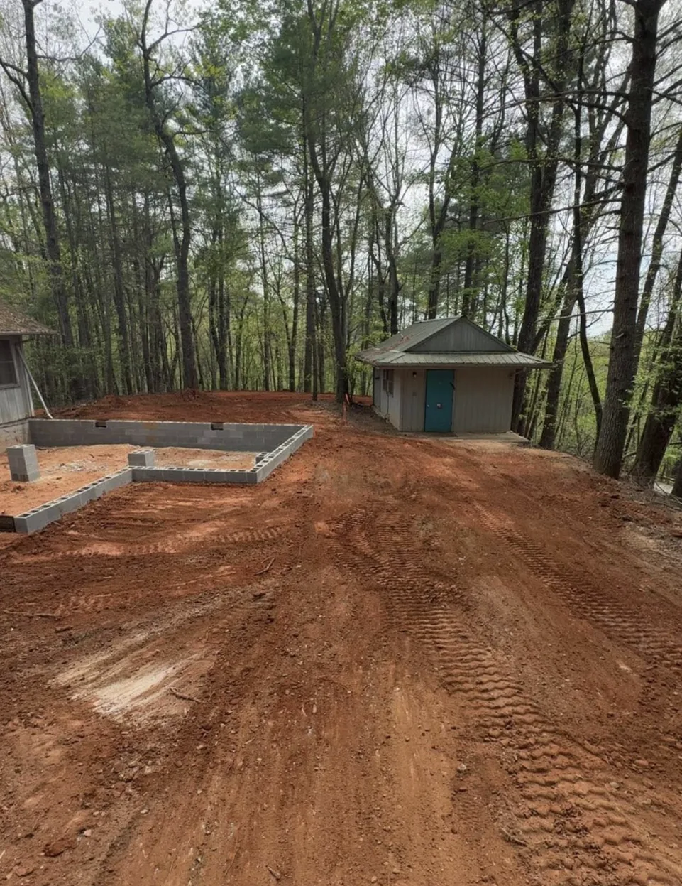 Graded building pad prepared on a wooded lot ready for construction